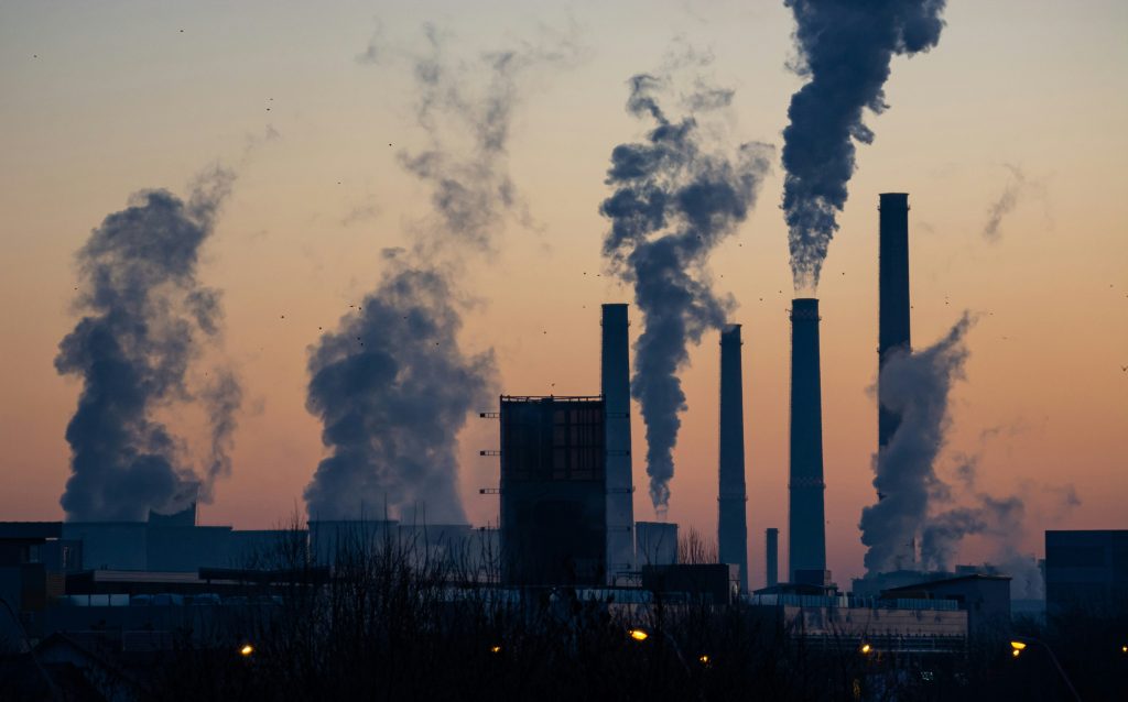 Industrial factory smoke stacks illustrating how environmental pollution and external factors can impact immune system health
