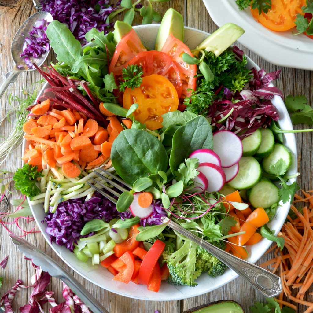 A bowl of fresh, colorful vegetables including radishes and greens, representing key nutrients for a strong immune system