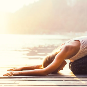A person practicing a yoga stretch as part of a balanced holistic health routine for mind and body wellness