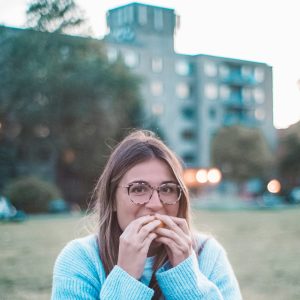 Happy woman eating for optimum mental health