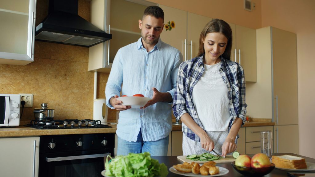 A couple preparing a healthy, nutrient-dense meal in their kitchen to support digestion after gallbladder removal